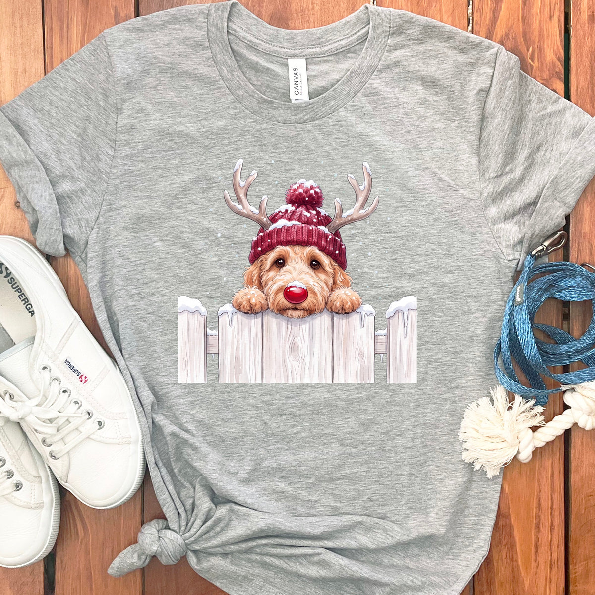 Gray t-shirt with a cartoon dog wearing a red beanie and reindeer antlers.