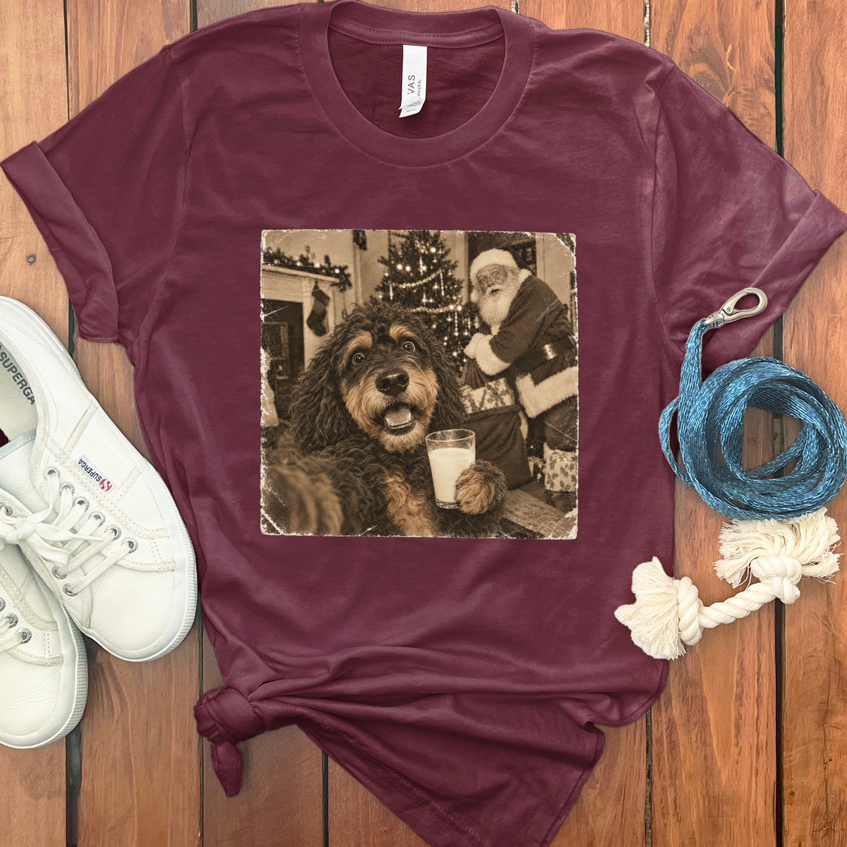 Maroon t-shirt featuring a vintage graphic of a dog holding a glass of milk next to Santa Claus.
