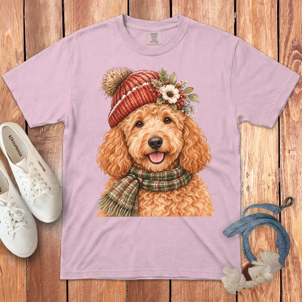 Pink t-shirt with watercolor doodle wearing a red knit hat and plaid scarf.