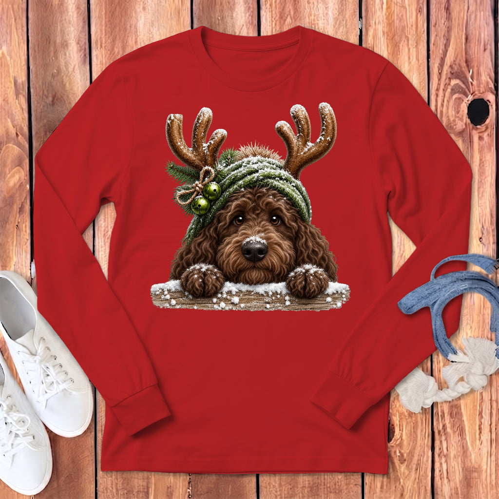 Red long-sleeve shirt featuring a fluffy brown dog wearing reindeer antlers and a green beanie.