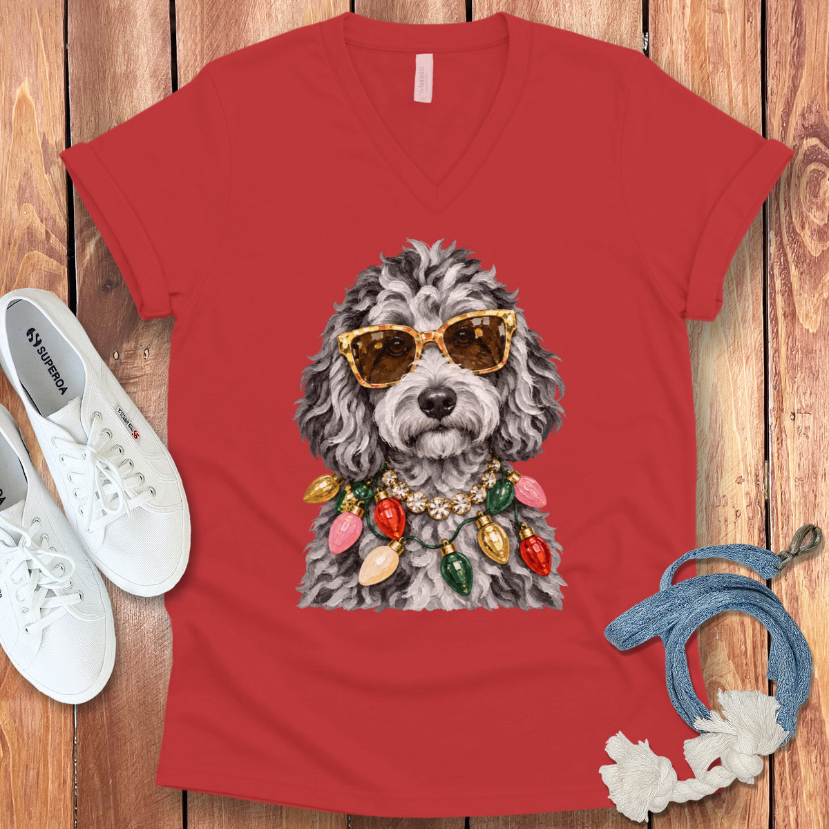 Red v-neck t-shirt with a printed doodle dog wearing sunglasses and Christmas lights.
