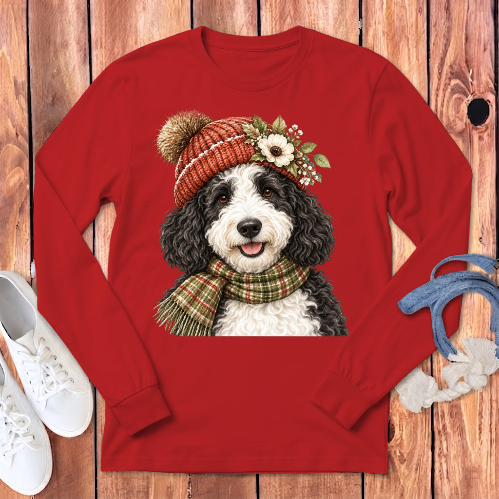 Long sleeve red t-shirt with a portrait of a fluffy dog wearing a knitted hat and scarf.