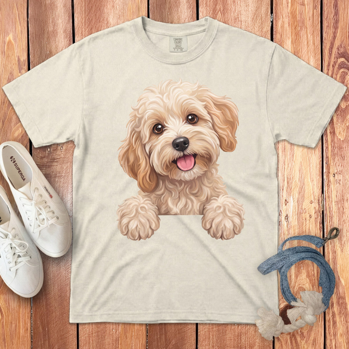 Cream t-shirt with a cheerful doodle dog graphic, white sneakers, and blue rope.