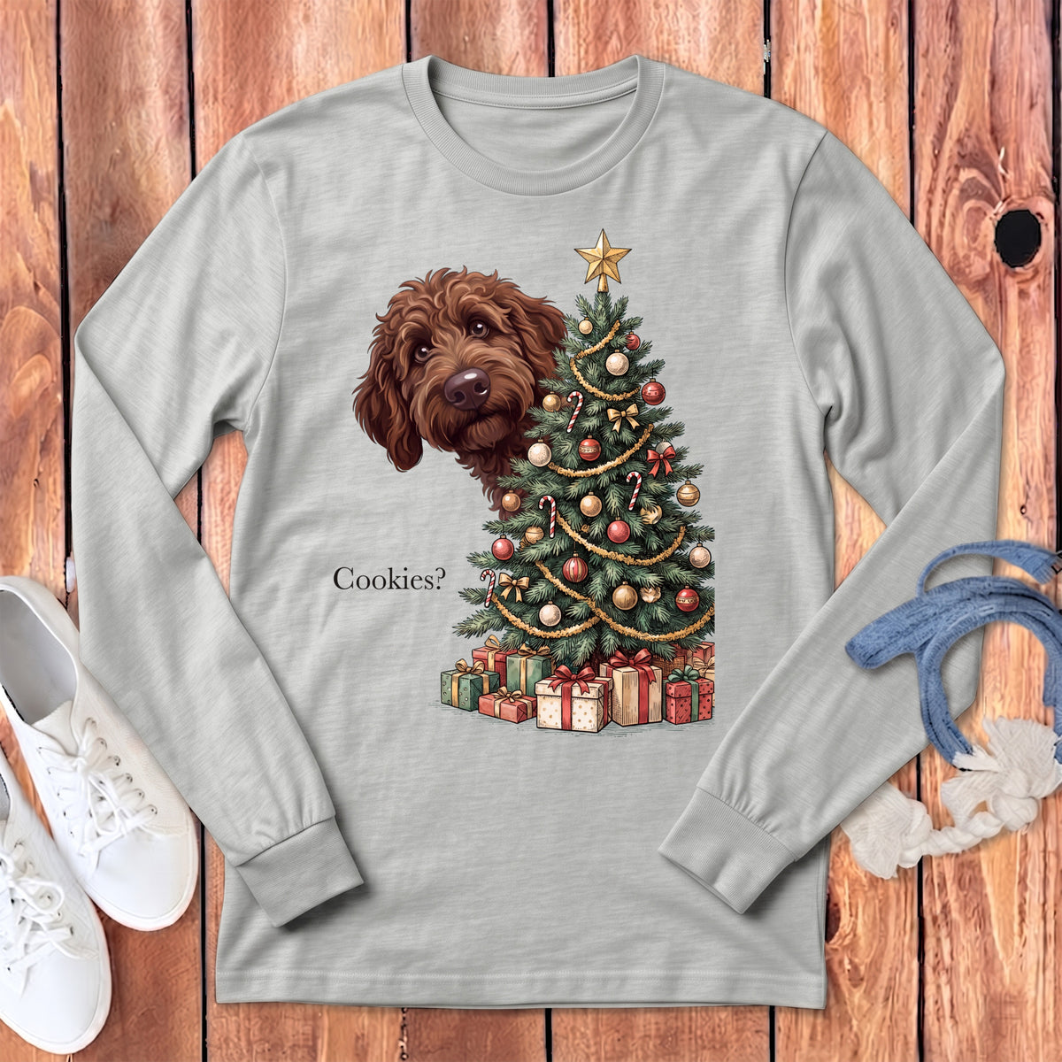 Light gray long sleeve shirt with brown dog peeking by a Christmas tree and gifts.