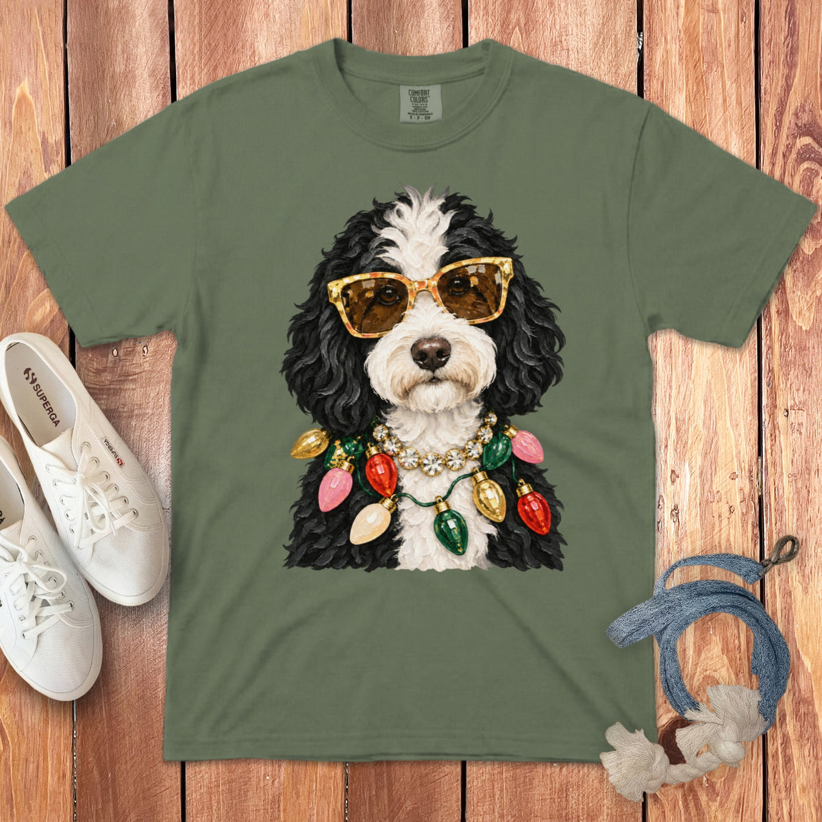 Green t-shirt with a dog wearing sunglasses and Christmas lights necklace.