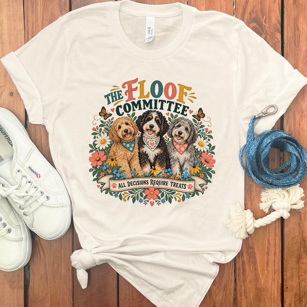 T-shirt with "The Floof Committee" and three dogs surrounded by flowers.