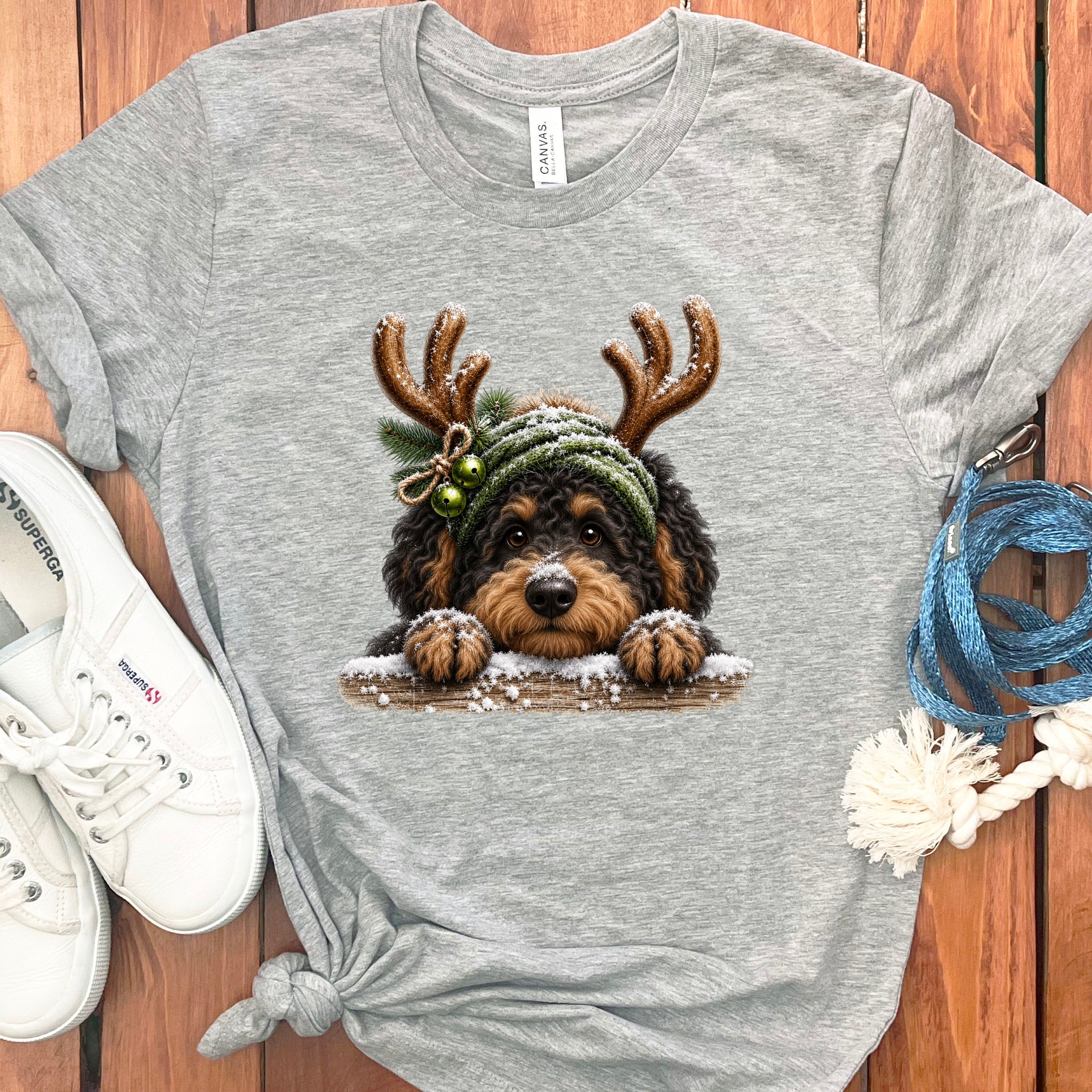 Grey t-shirt featuring a cute dog with antlers and snow detail.