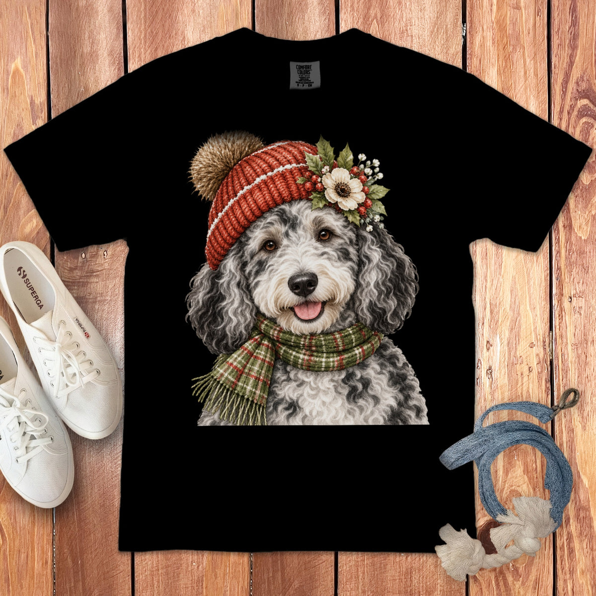 Black t-shirt with a doodle dog wearing a knit hat, scarf, and floral accents.