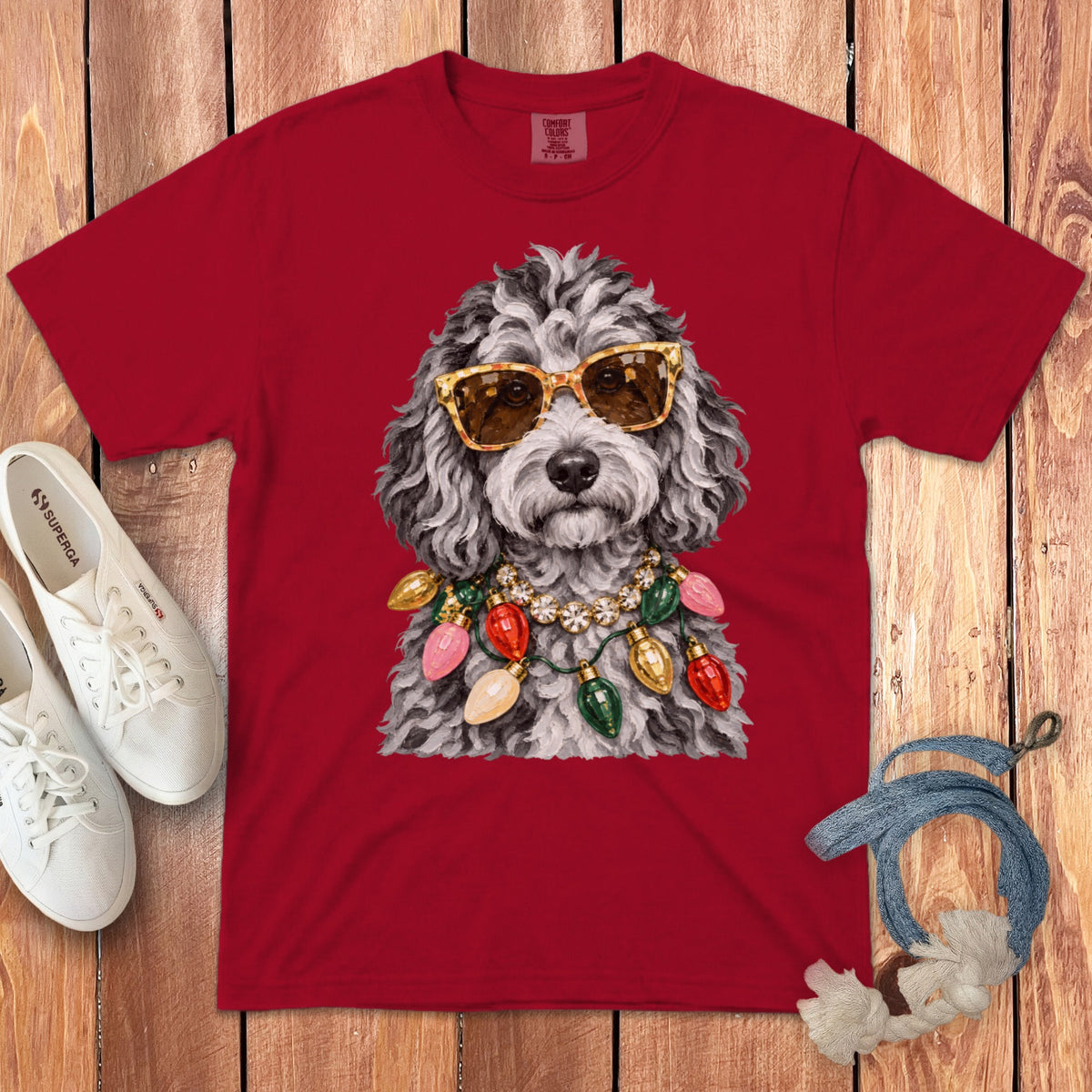 Red t-shirt with poodle wearing sunglasses and Christmas lights necklace.