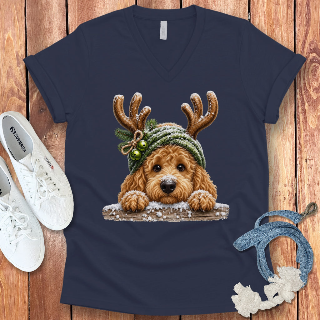 Dog wearing reindeer antlers and a green beanie with Christmas bells.