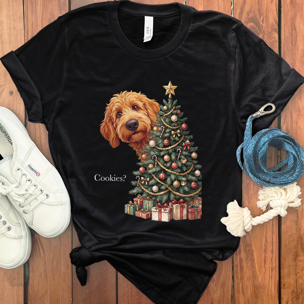 Black t-shirt with a dog peeking from behind a Christmas tree, text "Cookies?".