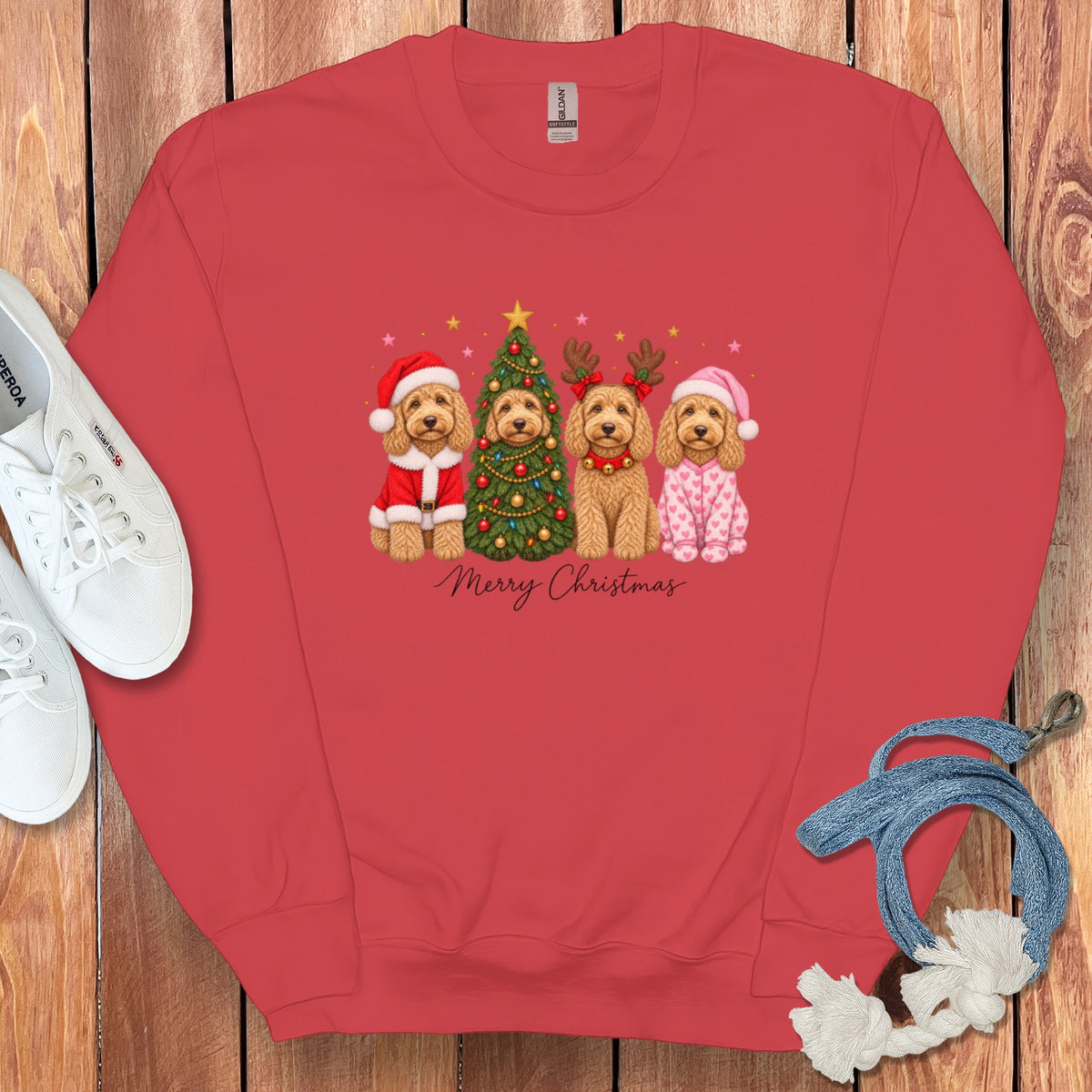 A red crewneck sweatshirt featuring a graphic of four dogs celebrating Christmas with the text Merry Christmas.