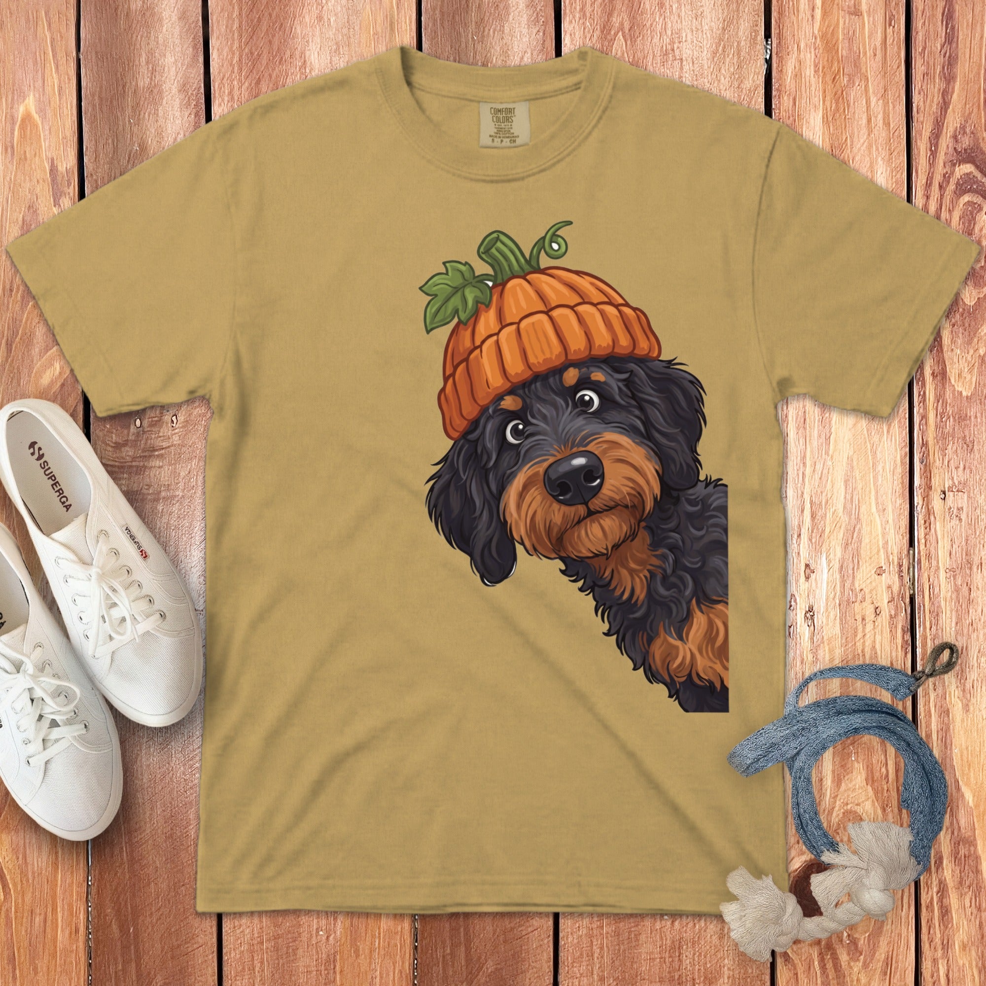 Yellow t-shirt with a black and brown dog wearing a pumpkin hat.