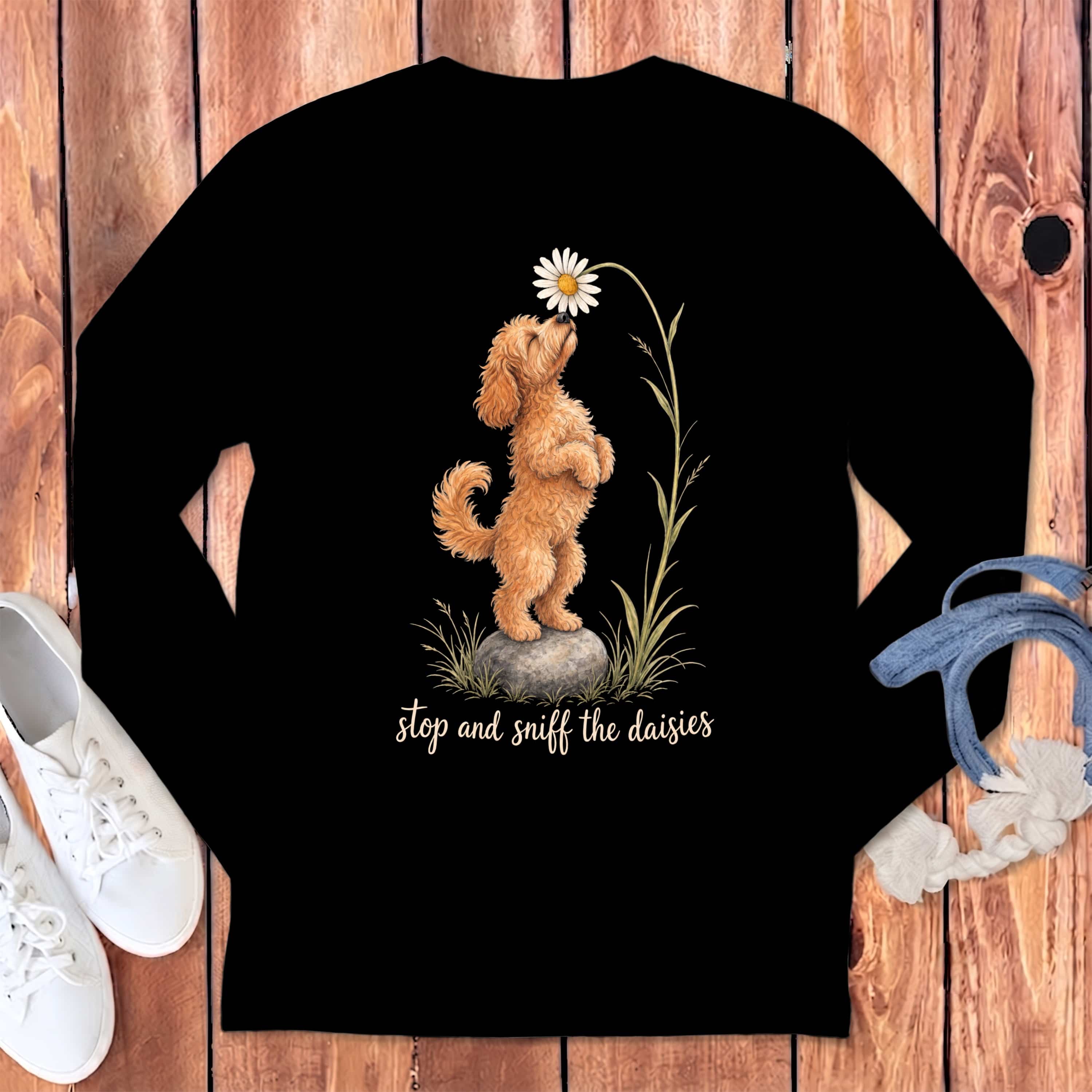 Black long-sleeve shirt with a doodle dog sniffing a daisy and text "stop and sniff the daisies".