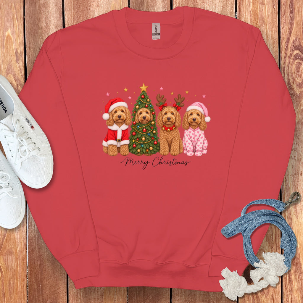 A red crewneck sweatshirt featuring a graphic of four doodle dogs in Christmas costumes with a tree.