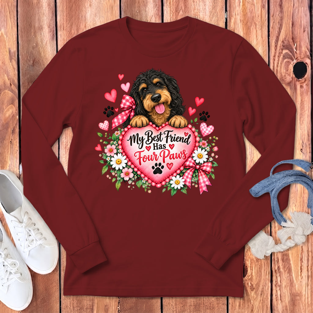 Maroon long-sleeved shirt with a graphic of a black dog, hearts, flowers, and text reading "My Best Friend Has Four Paws".