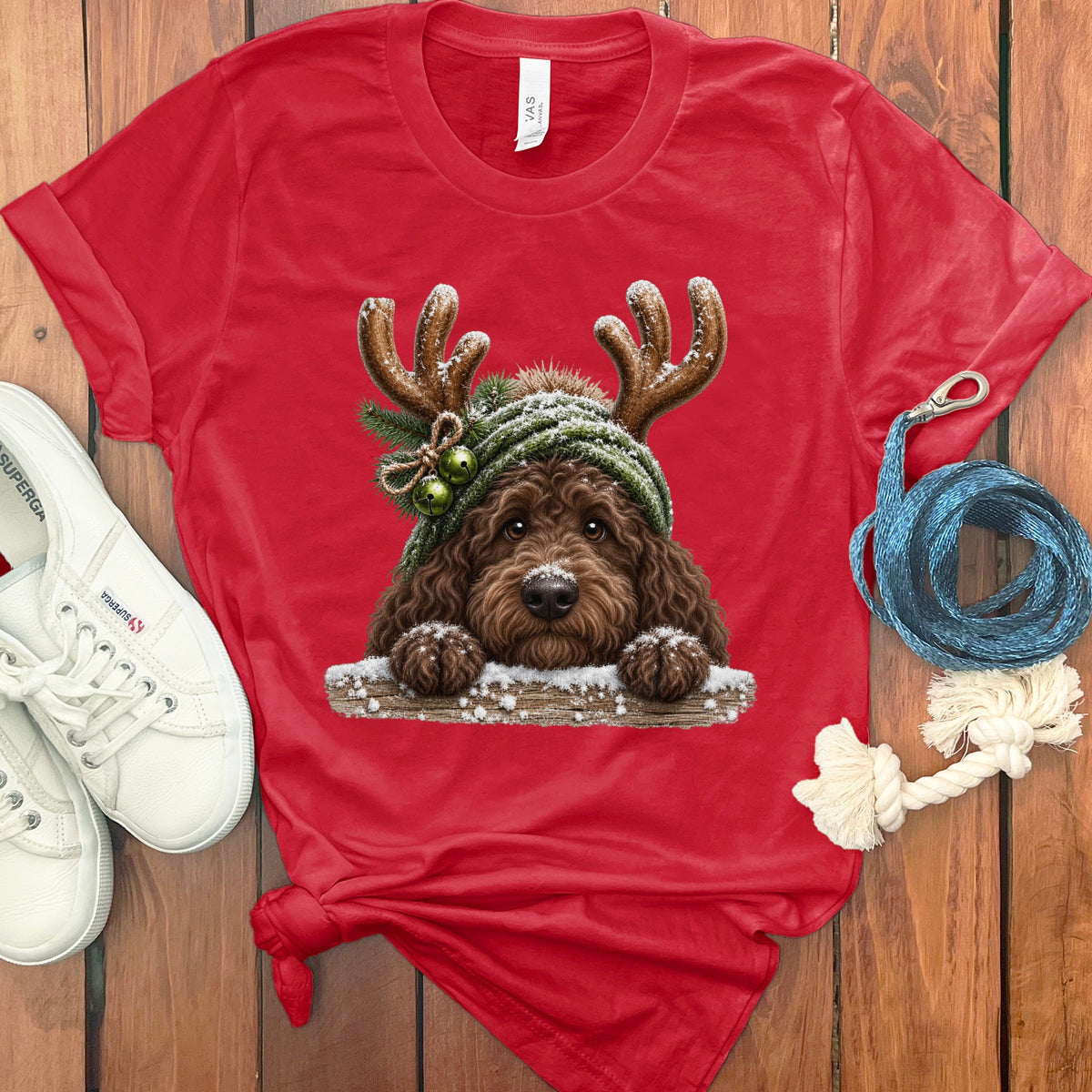 Red t-shirt with a doodle dog wearing antlers and a beanie with jingle bells.