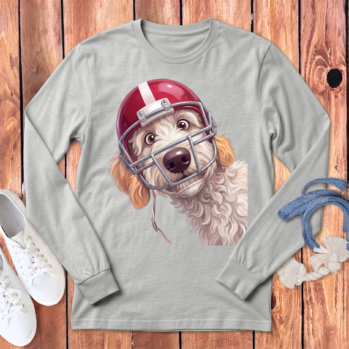 Gray long-sleeved t-shirt featuring a graphic of a curly-haired dog wearing a red football helmet.