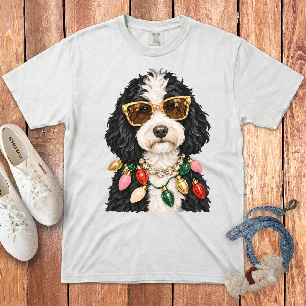 White t-shirt with a dog wearing sunglasses and Christmas lights.