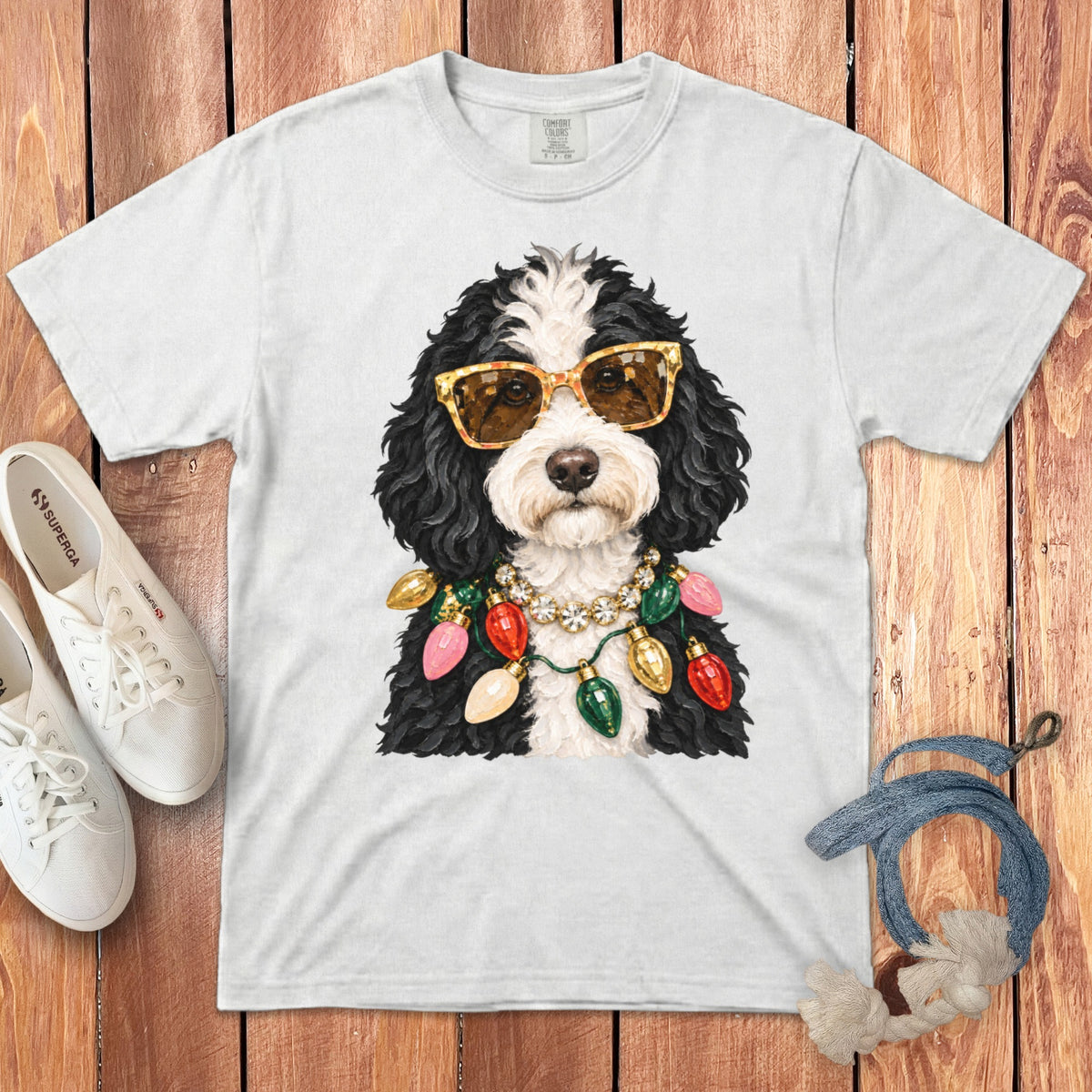 White t-shirt with a dog wearing sunglasses and Christmas lights.