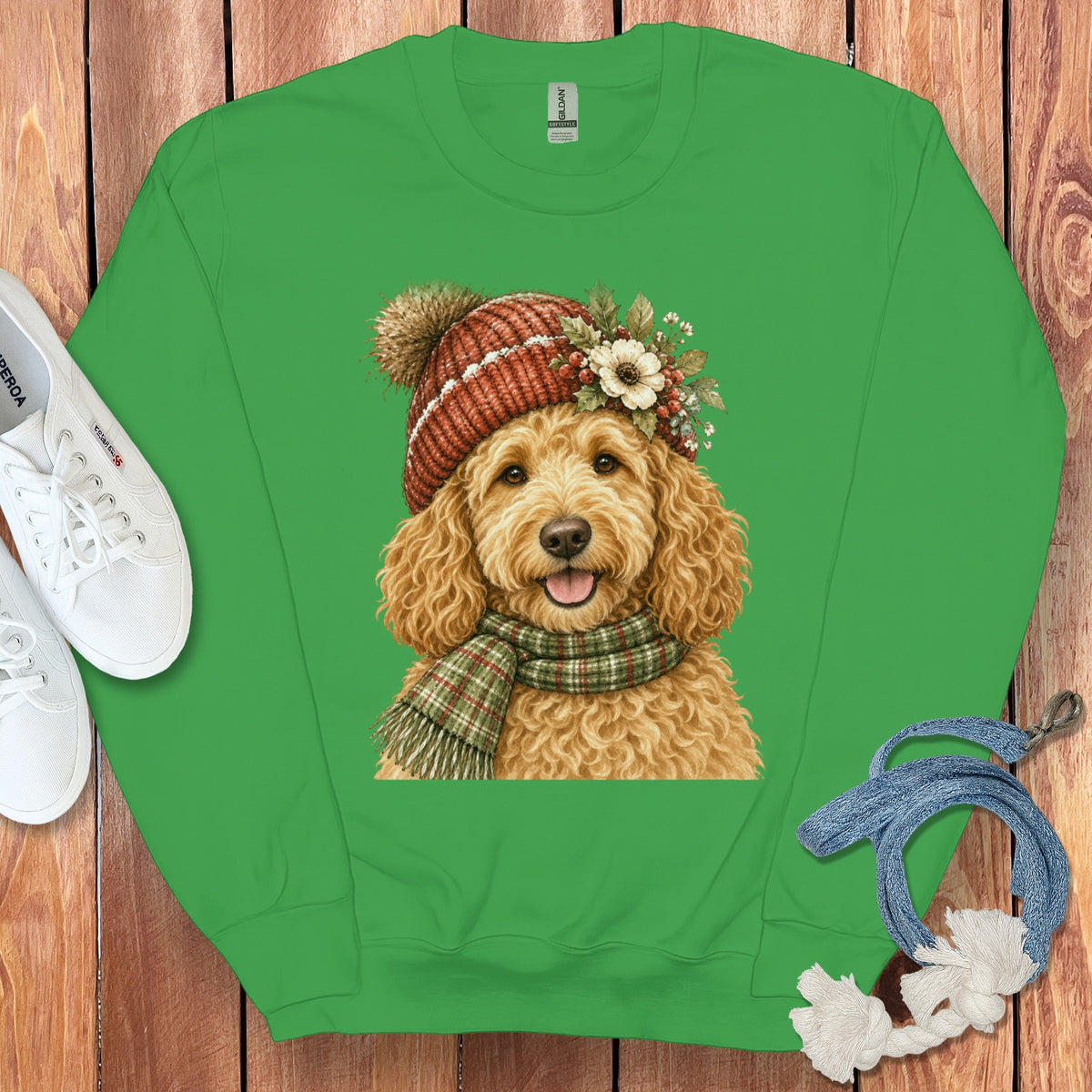Green crewneck sweatshirt with a watercolor-style print of a goldendoodle wearing a festive hat and scarf.