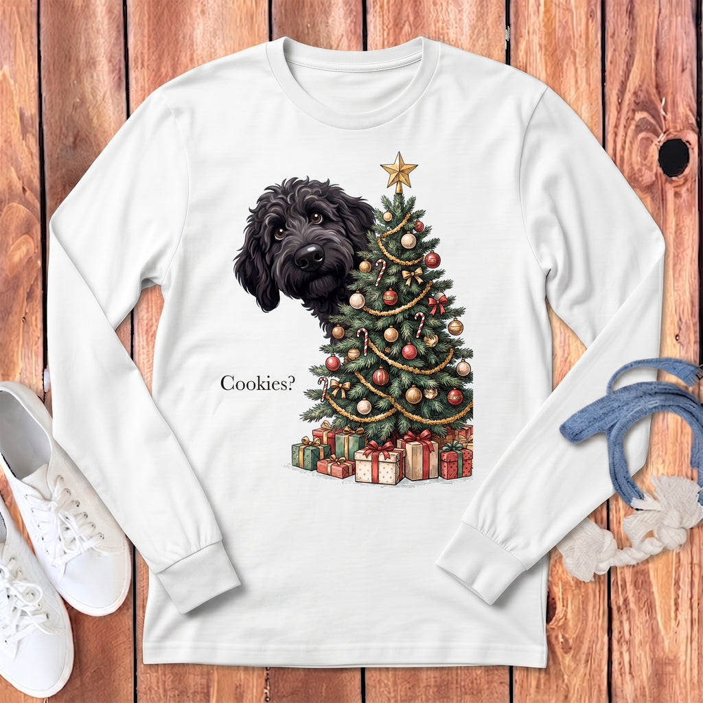 Black dog peeking from behind a decorated Christmas tree asking "Cookies?".