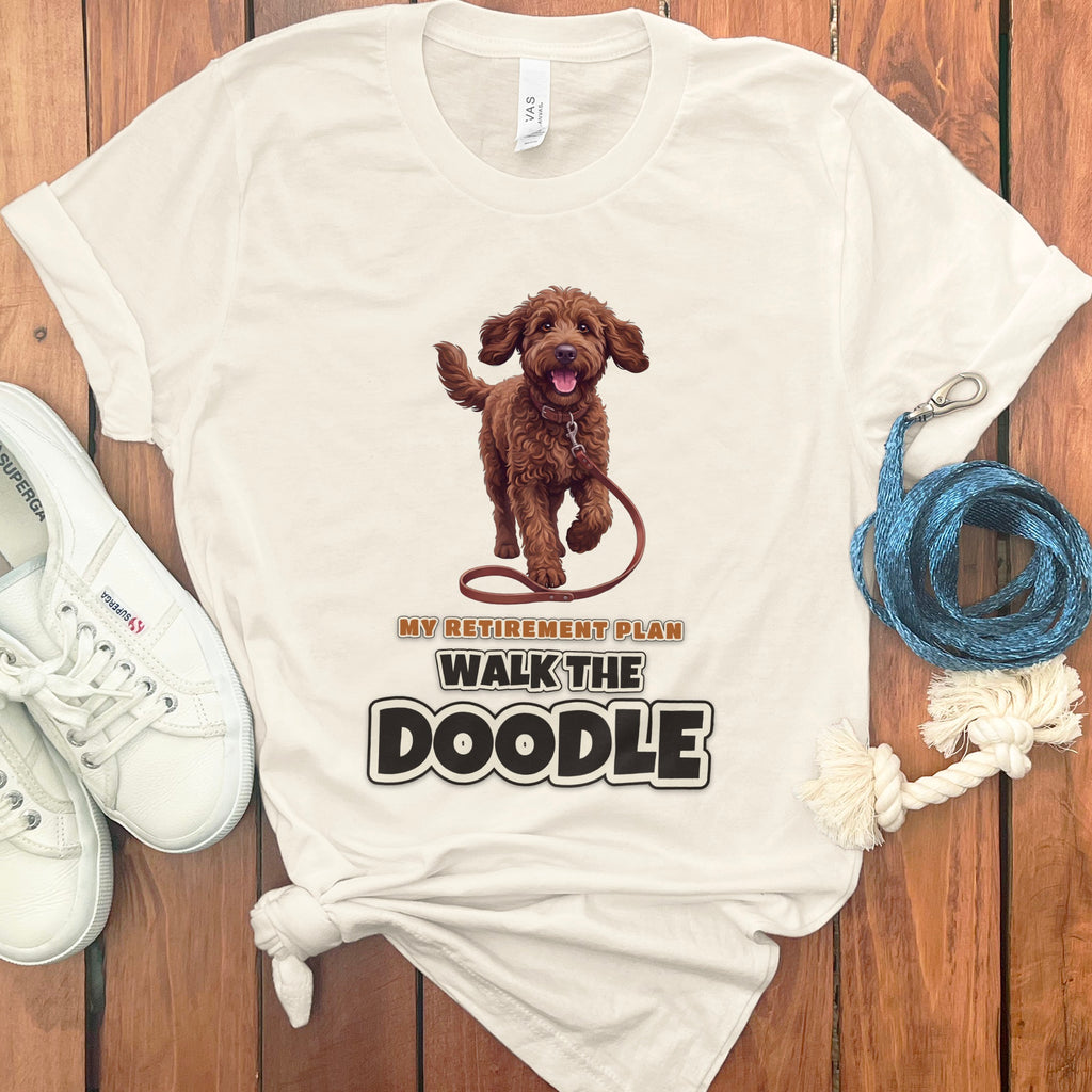Cream t-shirt with brown doodle graphic and "My Retirement Plan Walk The Doodle" text.