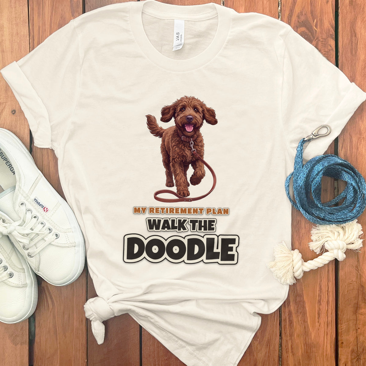 Cream t-shirt with brown doodle graphic and "My Retirement Plan Walk The Doodle" text.