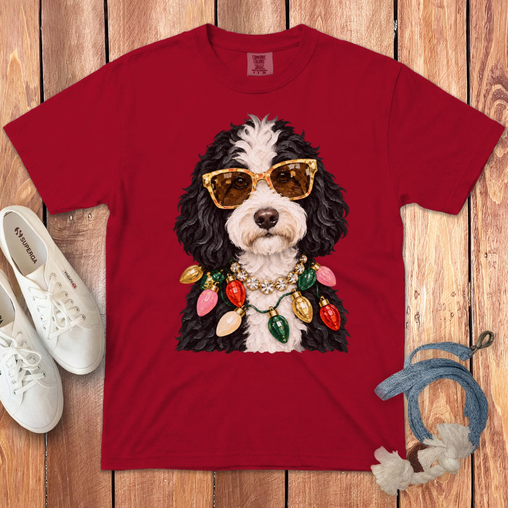 Red t-shirt with dog wearing sunglasses and Christmas lights necklace.