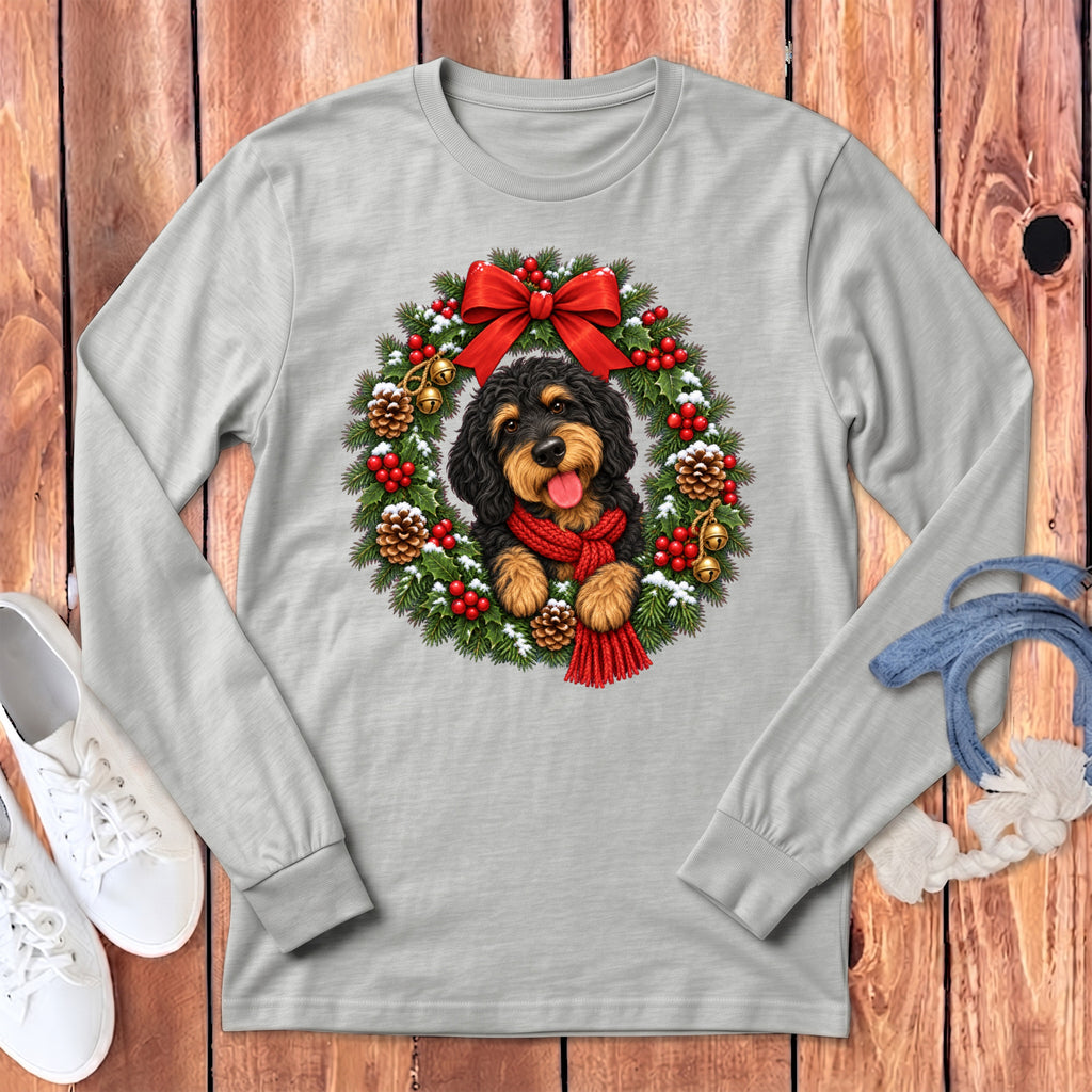 Light gray long-sleeve t-shirt featuring a doodle dog wearing a red scarf inside a Christmas wreath.