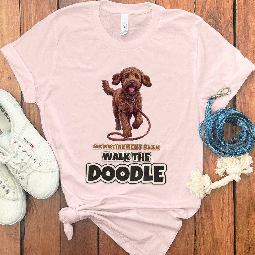 Light pink t-shirt with brown doodle dog graphic and "My Retirement Plan Walk the Doodle" text.