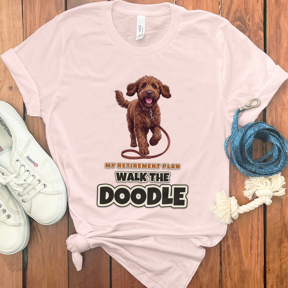 Light pink t-shirt with brown doodle dog graphic and "My Retirement Plan Walk the Doodle" text.