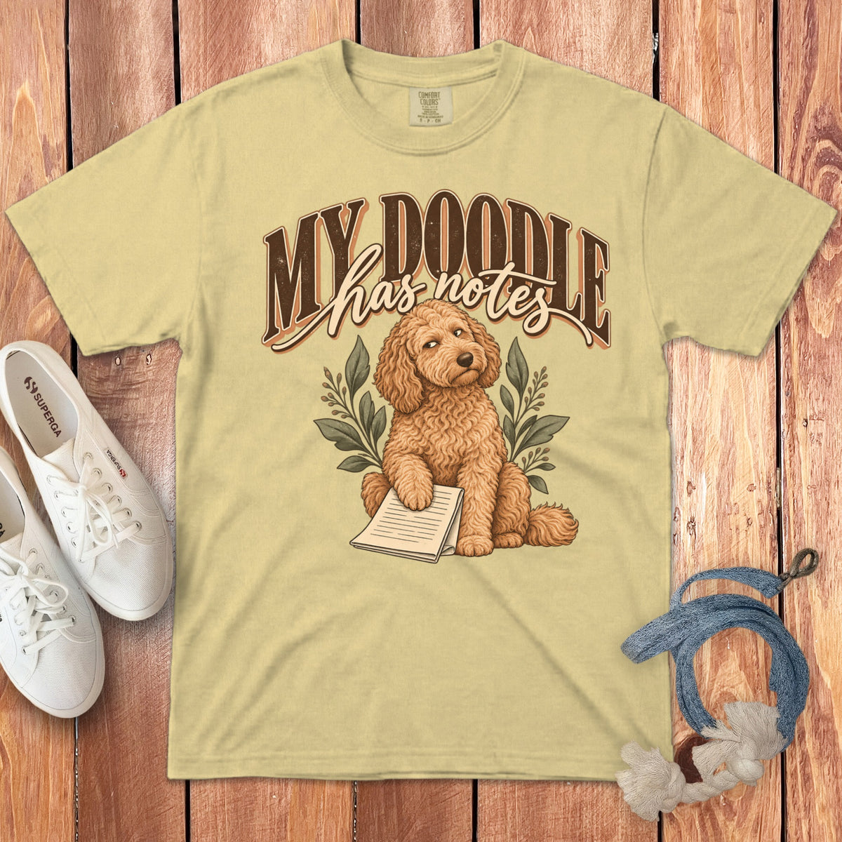 Light yellow t-shirt featuring a graphic of a curly brown doodle dog and the text MY DOODLE has notes.