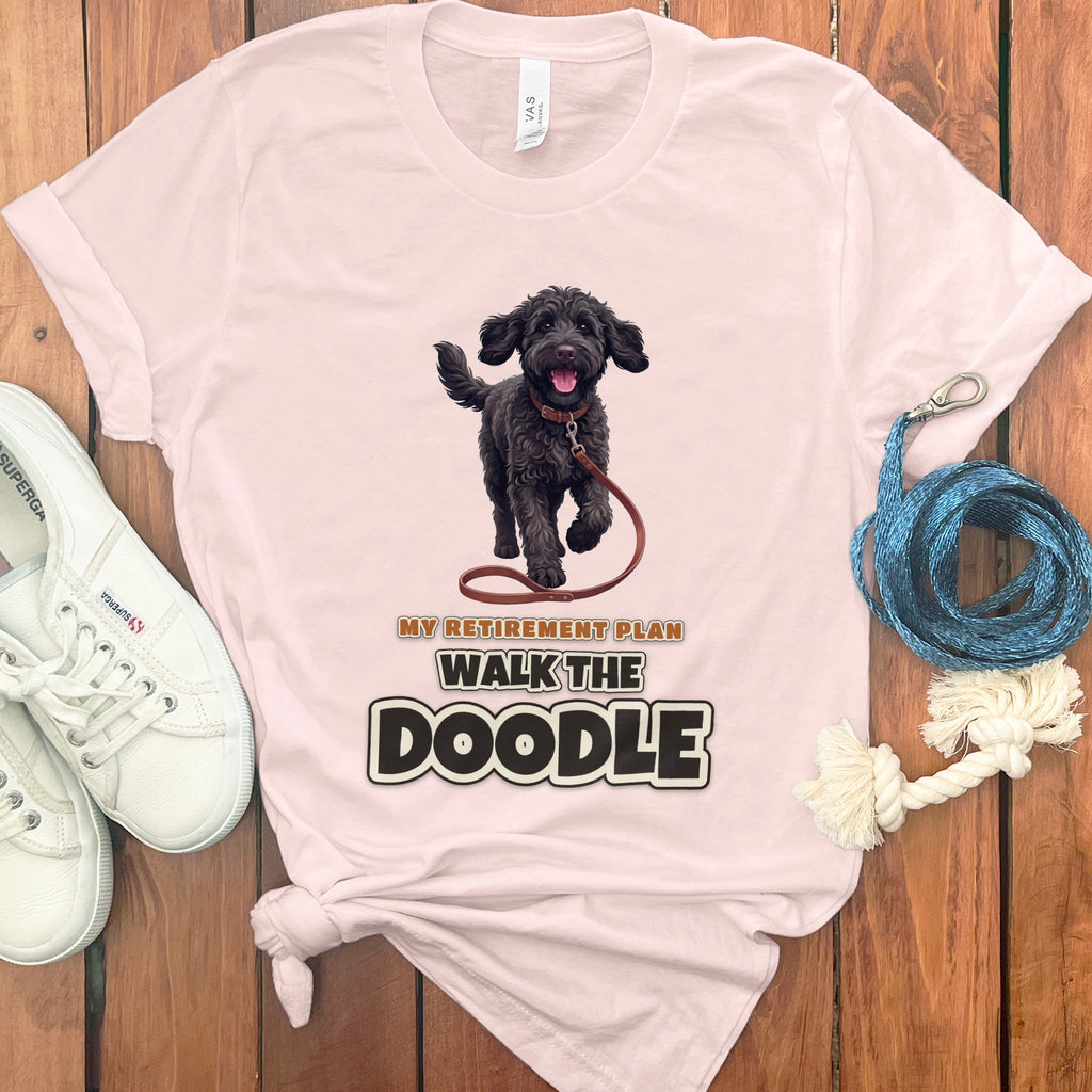 Pink t-shirt with a black doodle dog and text "MY RETIREMENT PLAN WALK THE DOODLE".