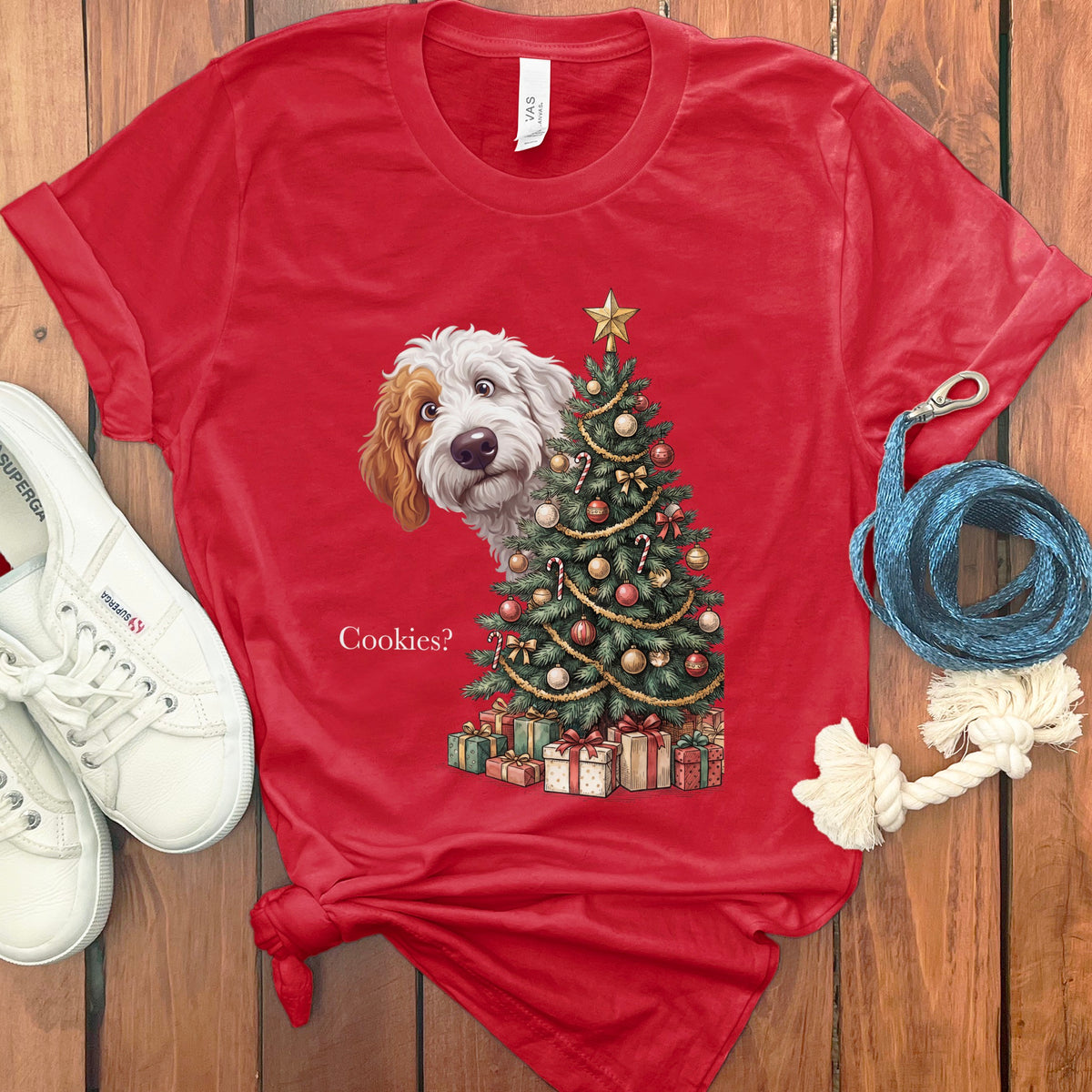 Red t-shirt with a dog peeking behind a Christmas tree and the text "Cookies?".