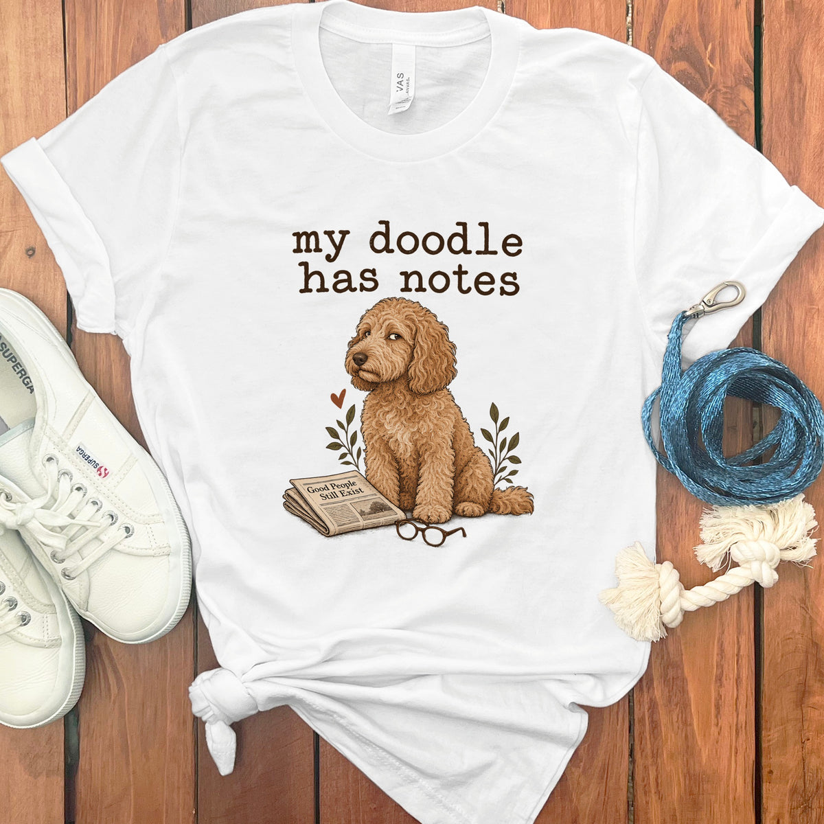 White t-shirt with text "my doodle has notes" and a doodle dog illustration.