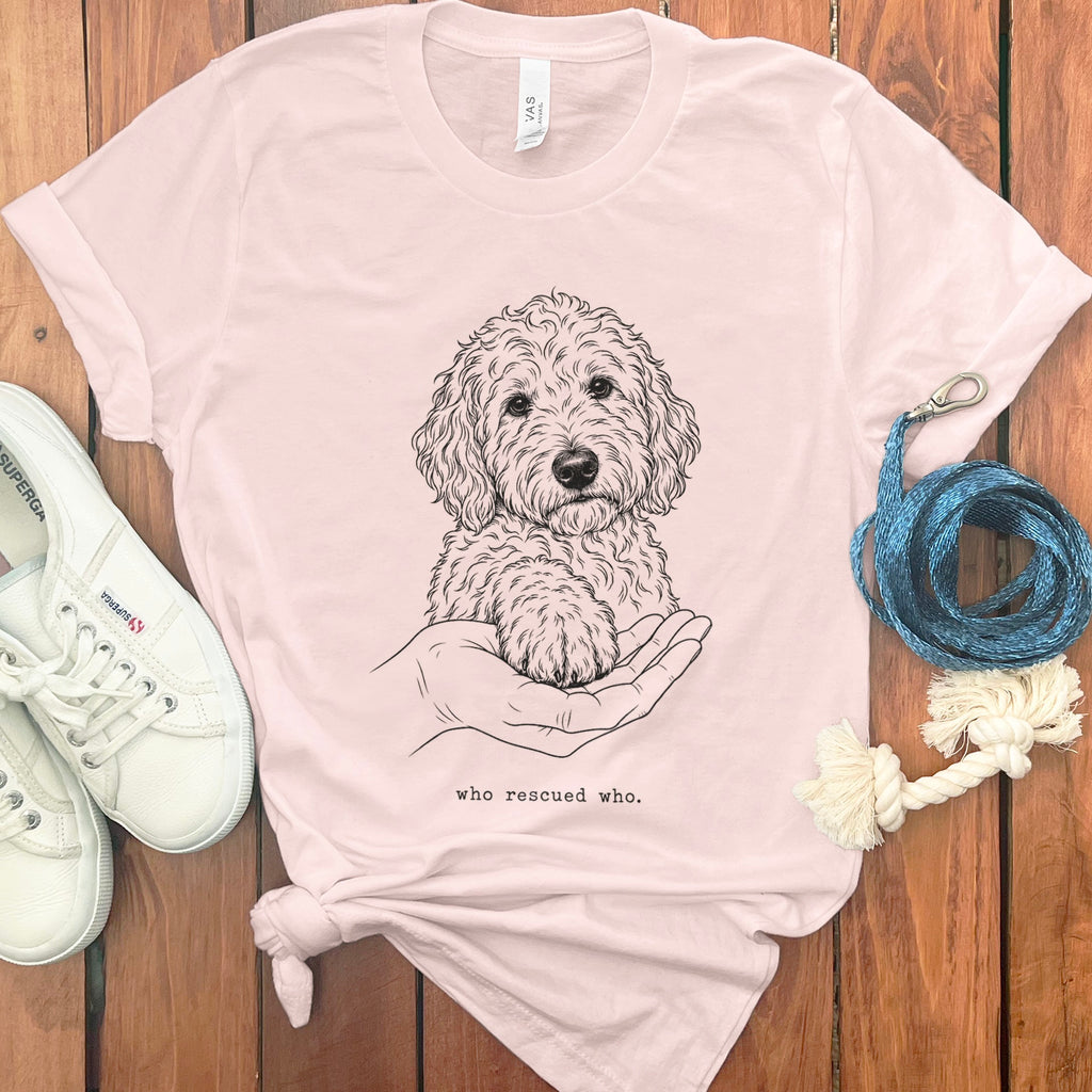 Line drawing of dog paw resting on a hand with text "who rescued who."