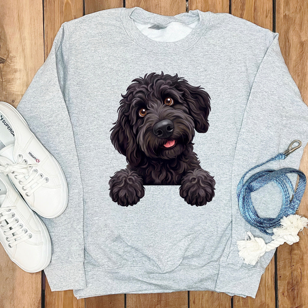 Grey sweatshirt with a black doodle dog graphic peeking over a pocket.