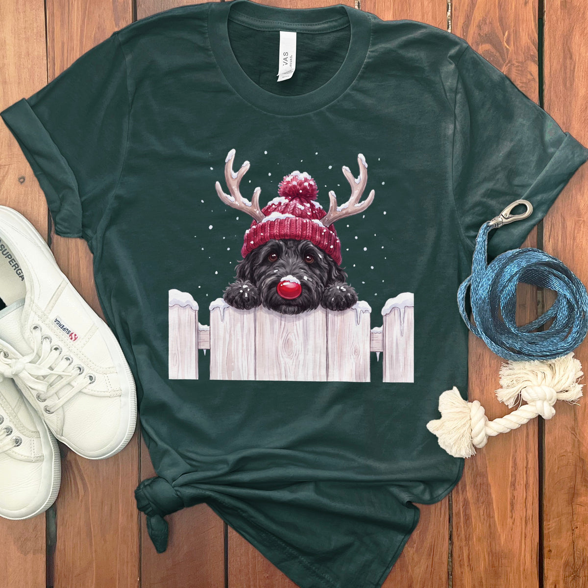 Dark green t-shirt featuring a black dog with reindeer antlers and red nose.
