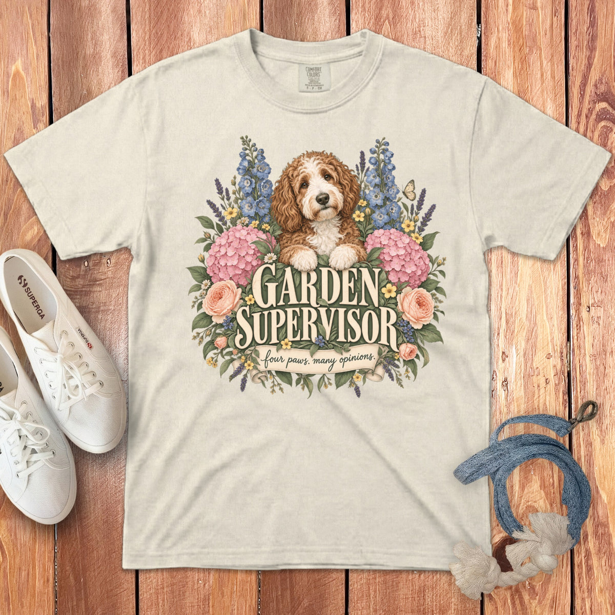 Beige t-shirt featuring a doodle dog surrounded by flowers and the text Garden Supervisor.