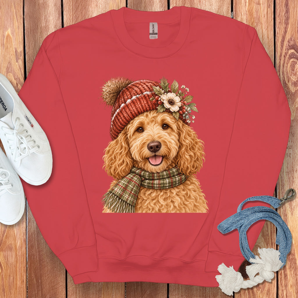 Crewneck sweatshirt with a watercolor illustration of a goldendoodle dog wearing a knit hat and scarf.