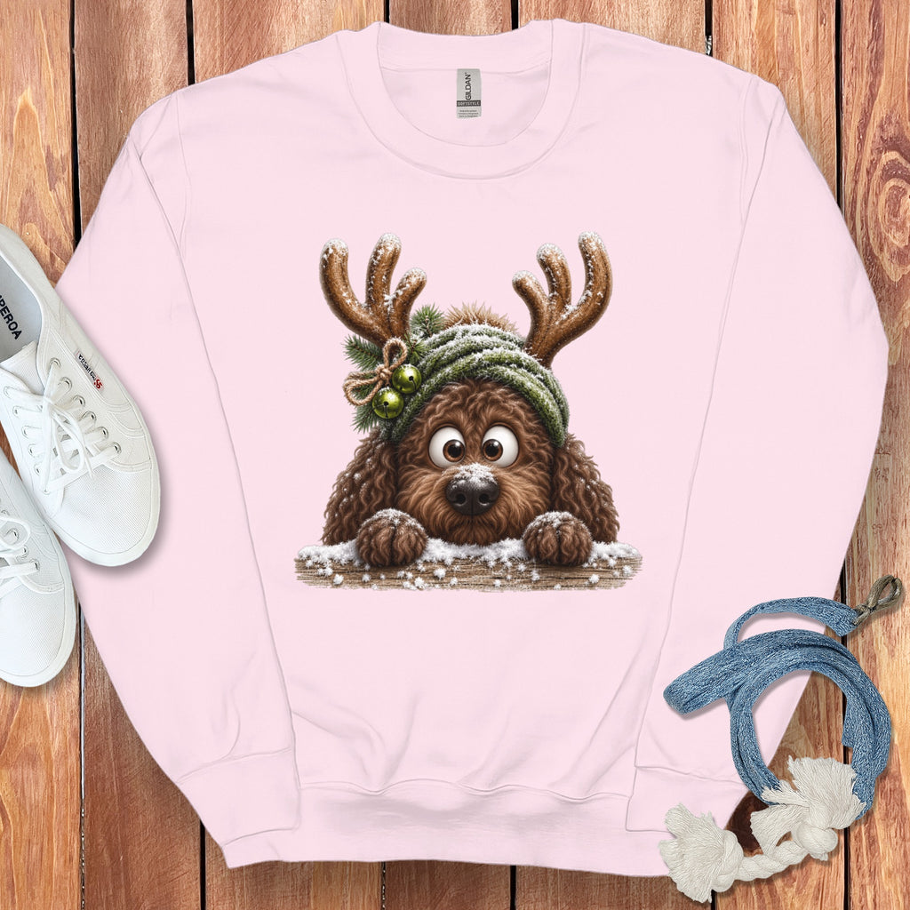 Pink crewneck sweatshirt with a cartoon brown dog wearing reindeer antlers and a green hat.