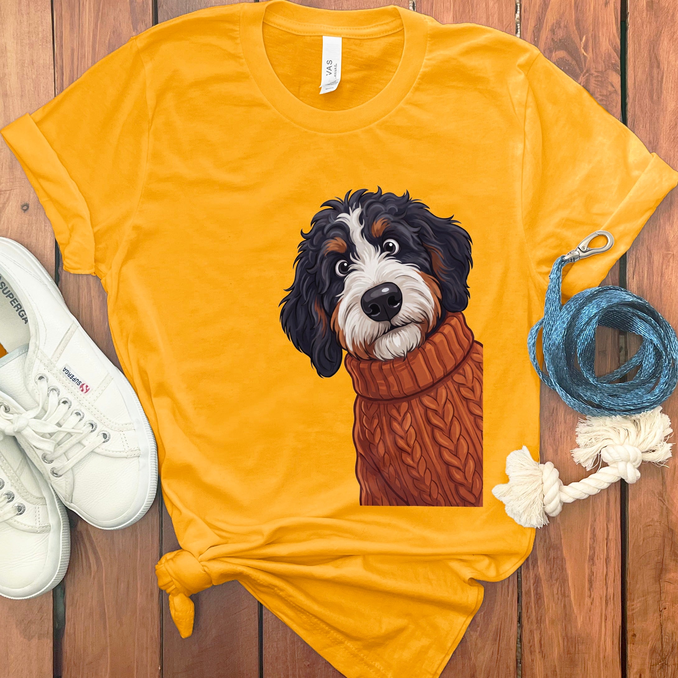 Yellow t-shirt with large Bernese Mountain Dog illustration wearing a sweater.