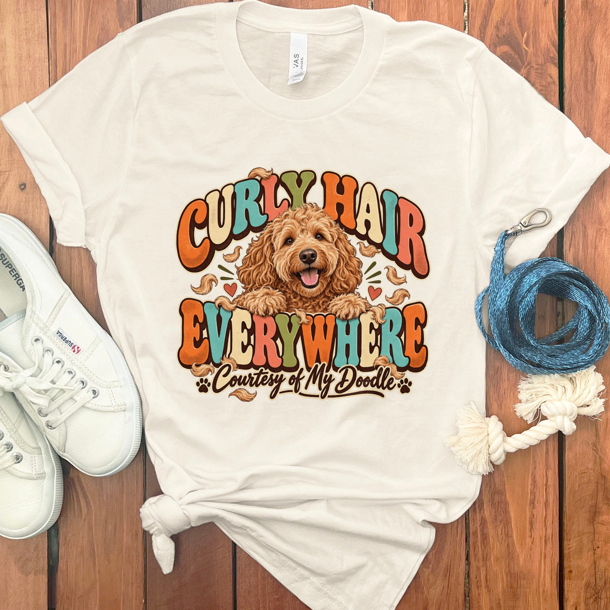 Cream t-shirt with doodle dog graphic and text: Curly Hair Everywhere, Courtesy of My Doodle.