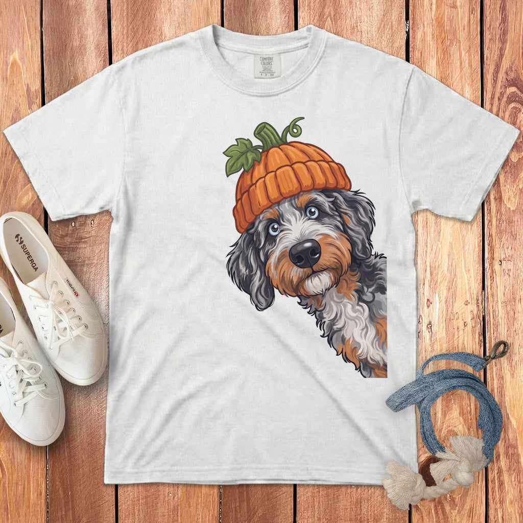 White t-shirt with tri-color dog wearing a pumpkin hat and peeking from the side.