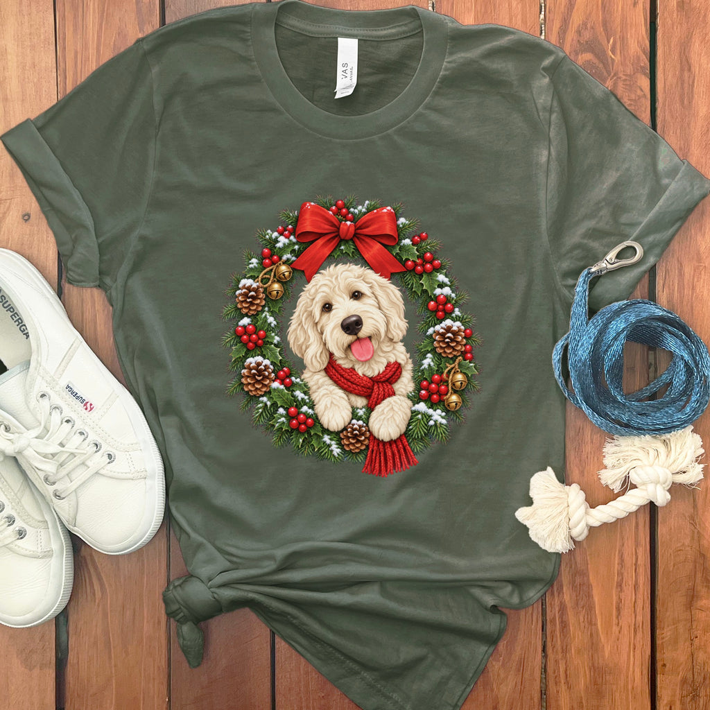 Dark green t-shirt featuring a Golden Doodle wearing a red scarf inside a Christmas wreath.
