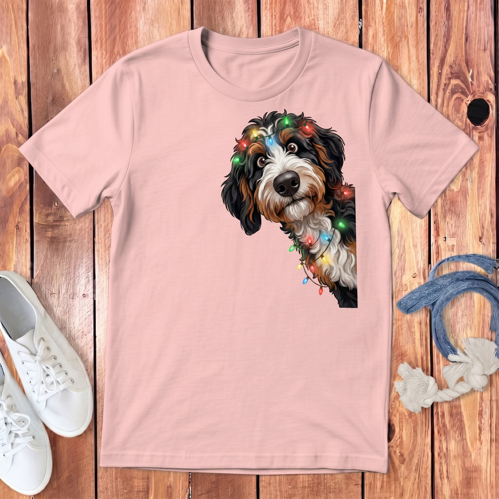 Bernese mountain dog with colorful Christmas lights printed on a pink t-shirt.