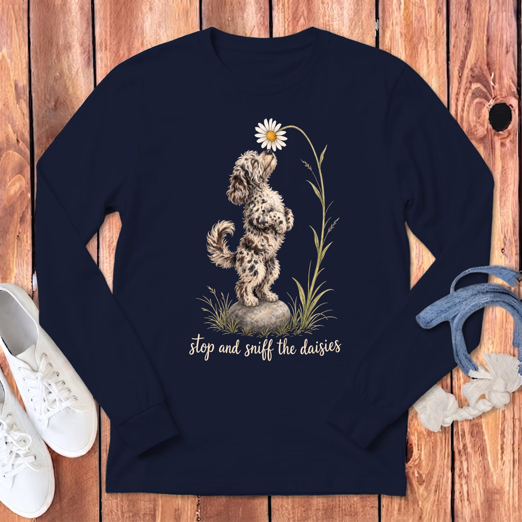 Navy long sleeve shirt with dog and daisy graphic and text "stop and sniff the daisies."