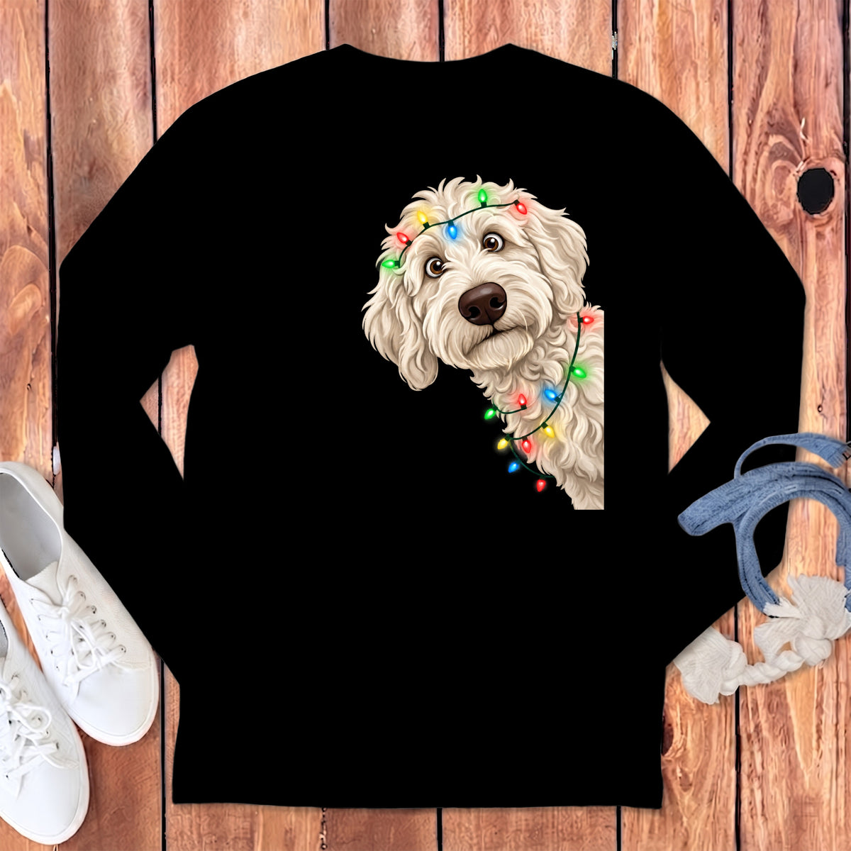 White doodle dog with colorful Christmas lights on black long-sleeve shirt