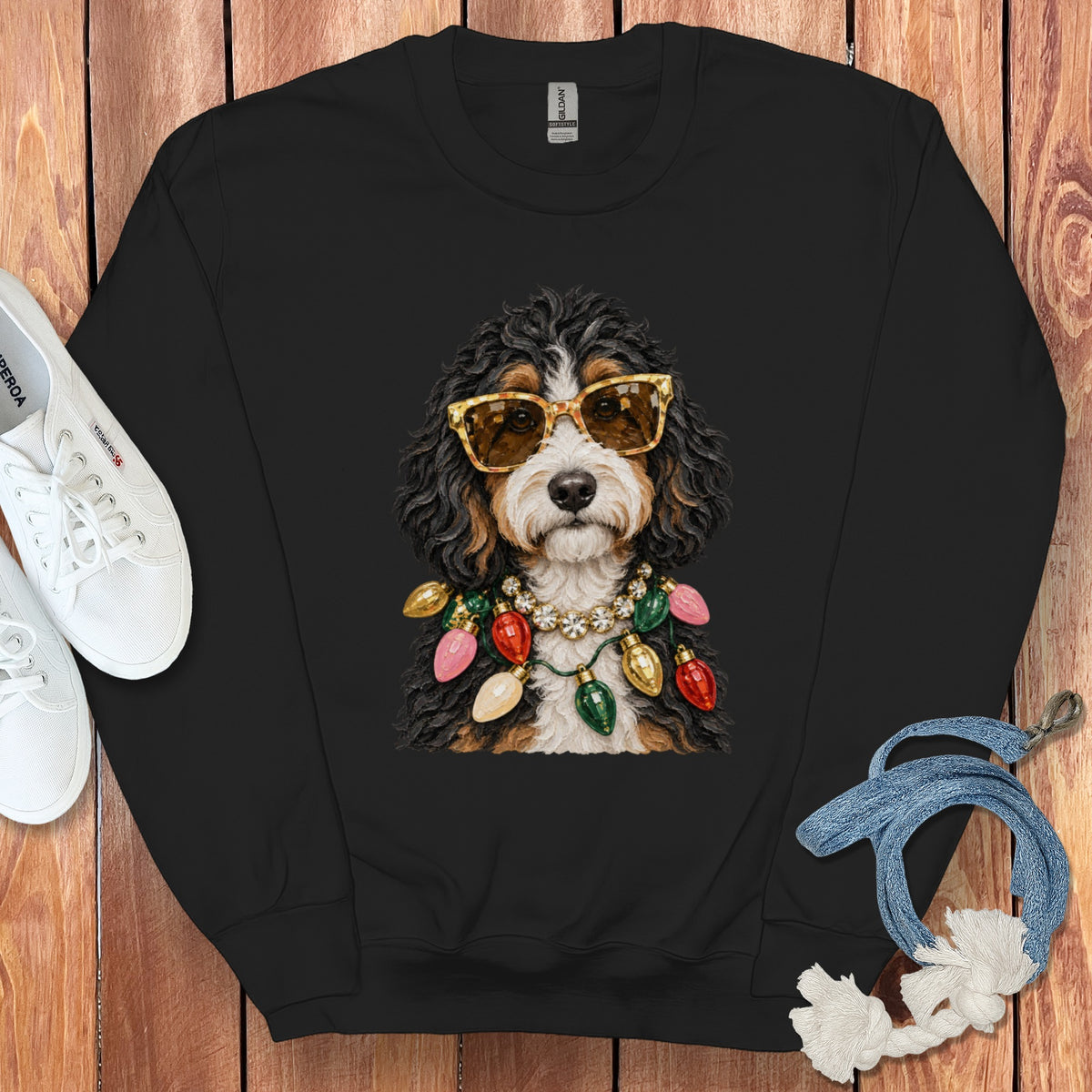 Bernese Mountain Dog wearing sunglasses and a string of Christmas lights.